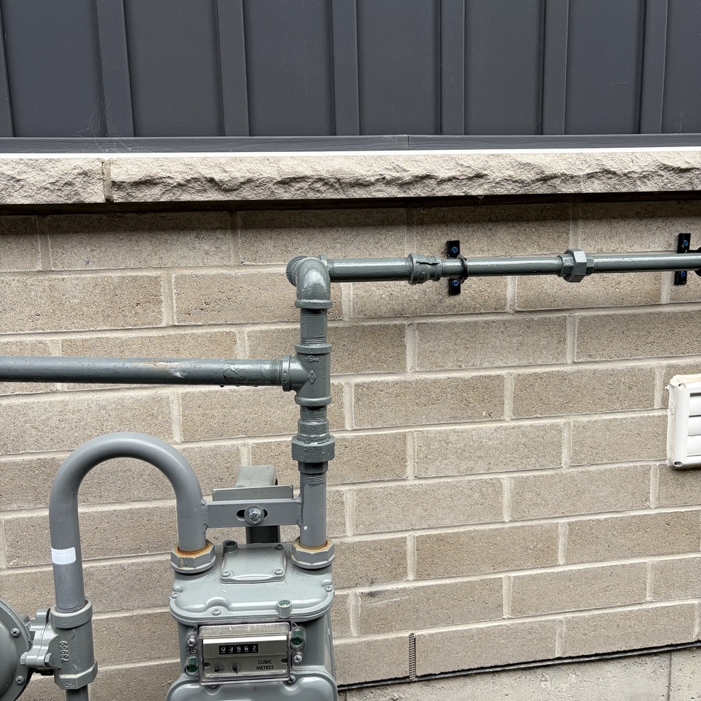 Technician installing a new black-iron gas line